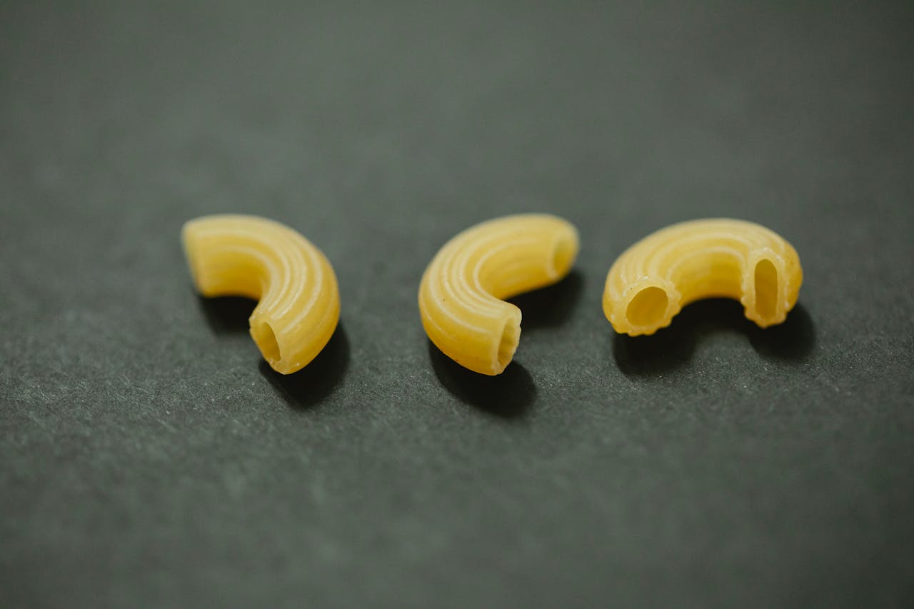 services-img From above of uncooked curvi rugati macaroni placed on gray table in kitchen